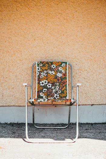 Yellow and Gray Floral Armchair Near Wall