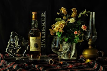 Yellow and Pink Roses in Vase Beside Wine Bottle Close-up Photography
