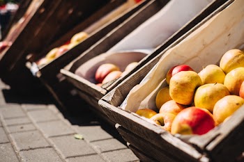Yellow and Red Apples on Brown Crate