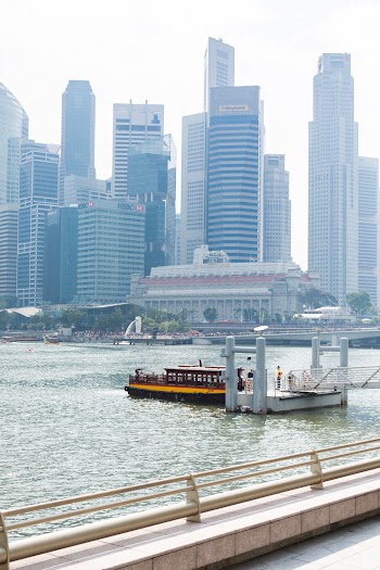 Yellow and Red Boat Across City Building
