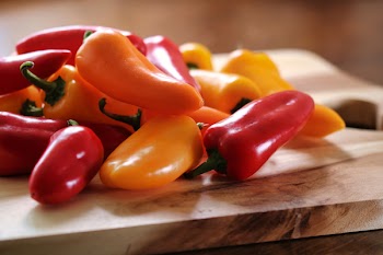 Yellow and Red Peppers on Table