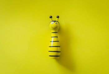 Yellow and White Ceramic Bee Table Decor on Yellow Surface