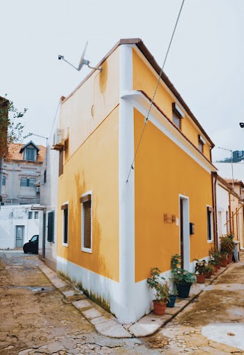Yellow and White Concrete Roadside House