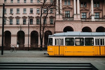 yellow and white train near building