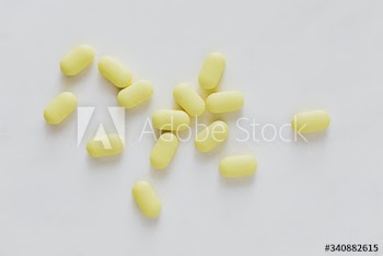 Yellow antibiotics on a white background