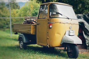 Yellow Auto Rickshaw Carrying Firewood
