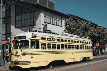 Yellow Bus on the Road Near Buildings
