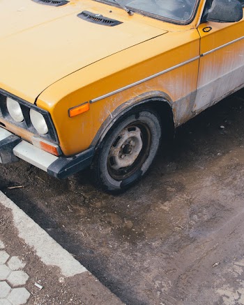 Yellow Car Parked Near Street Curb