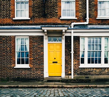 Yellow Door On Brick Home