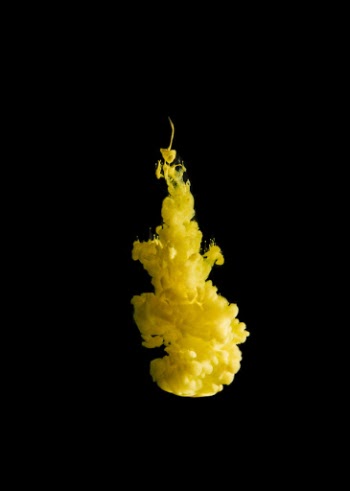 Yellow ink drop on black