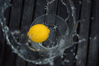 yellow lemon on drinking glass