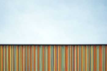 yellow, orange, and blue wooden fence
