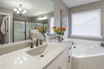 Yellow, Orange, and Red Rose Flower Centerpiece on White Ceramic Sink