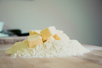 Yellow Pastry on White Powder on Brown Wooden Table