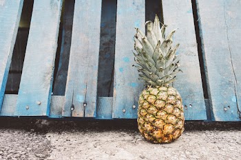 Yellow Pineapple Fruit Beside Blue Wooden Pallet