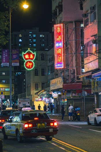 Yellow Sedan on Road at Night Time