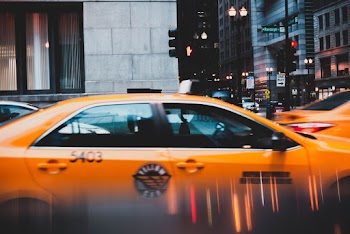 Yellow Sedan Parked Near Concrete Building