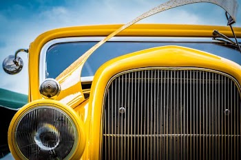 yellow vehicle in closeup photography during daytime