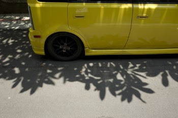 Yellow Vehicle Parked on Pavement