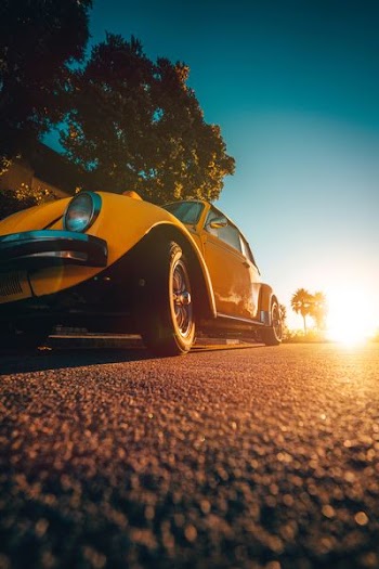 yellow Volkswagen Beetle coupe during golden hour