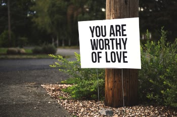 You Are Worthy of Love Signage on Brown Wooden Post Taken