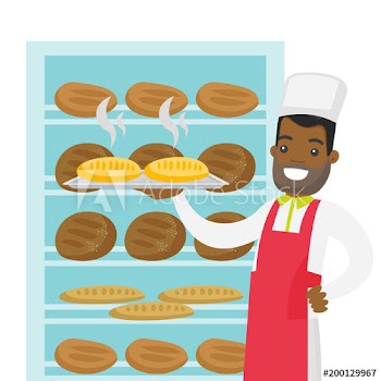 Young african-american baker in chef hat and apron holding a tray with bread in the bakery
