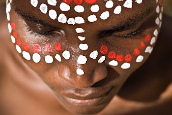 Young African girl, tribal painted face in white and red