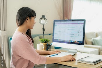Young asian businesswoman using computer work from home for protect virus and take care of their health from COVID-19. Working at home and social distancing concept.