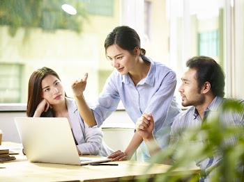 Young asian corporate executives meeting in office discussing business targets