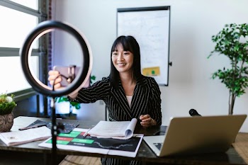Young Asian Woman Engaging in Remote Work with Ring Light