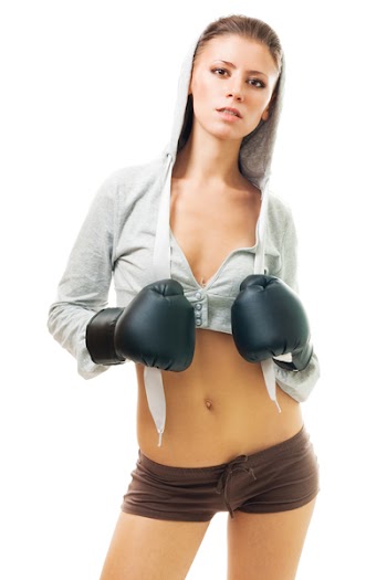 Young beautiful confident woman in boxing gloves, front view,isolated