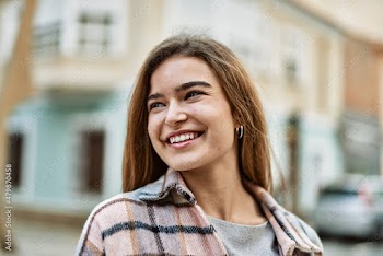 Young blonde woman smiling confident at street