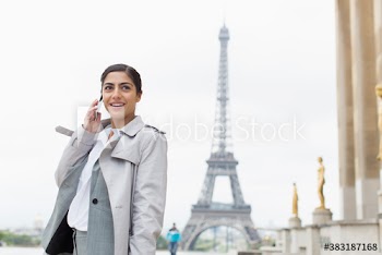 Young businesswoman talking on smart phone near Eiffel Tower, Paris