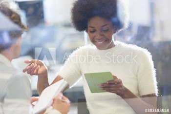 Young businesswoman using digital tablet in meeting