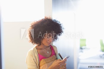 Young businesswoman using smart phone in office