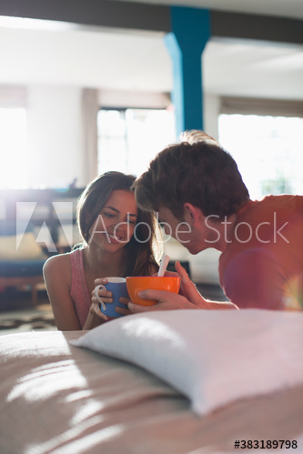 Young couple enjoying breakfast in apartment