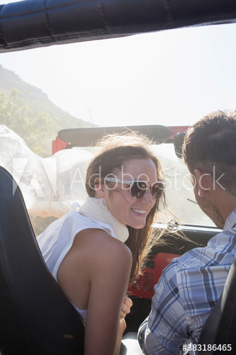 Young couple in sunny jeep