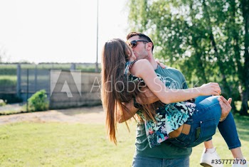 Young couple kissing each other outdoors
