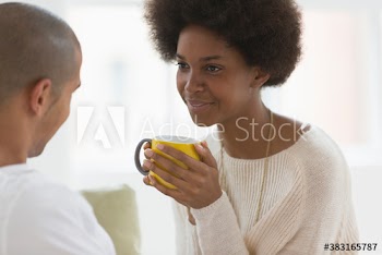 Young couple talking and drinking tea
