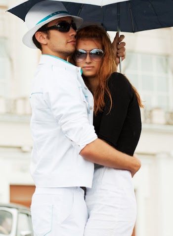 Young couple with umbrella.
