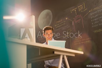 Young creative businessman working at digital tablet in office