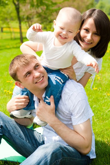 Young family playing in a spring park