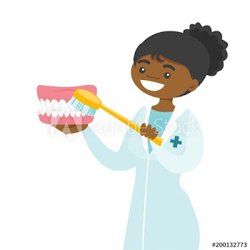 Young female african-american dentist cleaning dental jaw model with a toothbrush