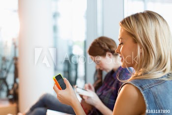 Young female college student using smart phone