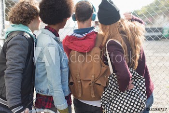 Young friends at chainlink fence