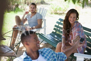 Young friends hanging out in backyard