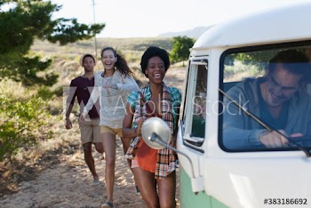 Young friends running toward van