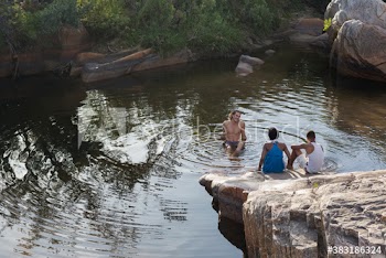 Young friends swimming and relaxing at lake