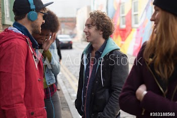 Young friends talking on city street