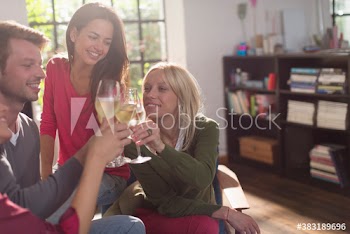Young friends toasting white wine glasses